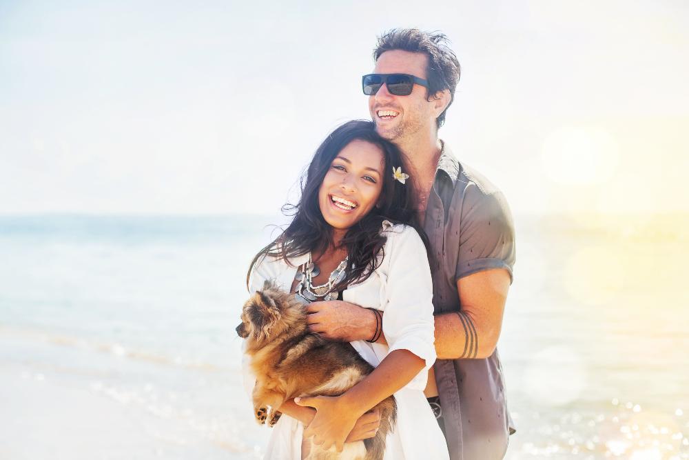 young couple hugging on beach | braces parramatta