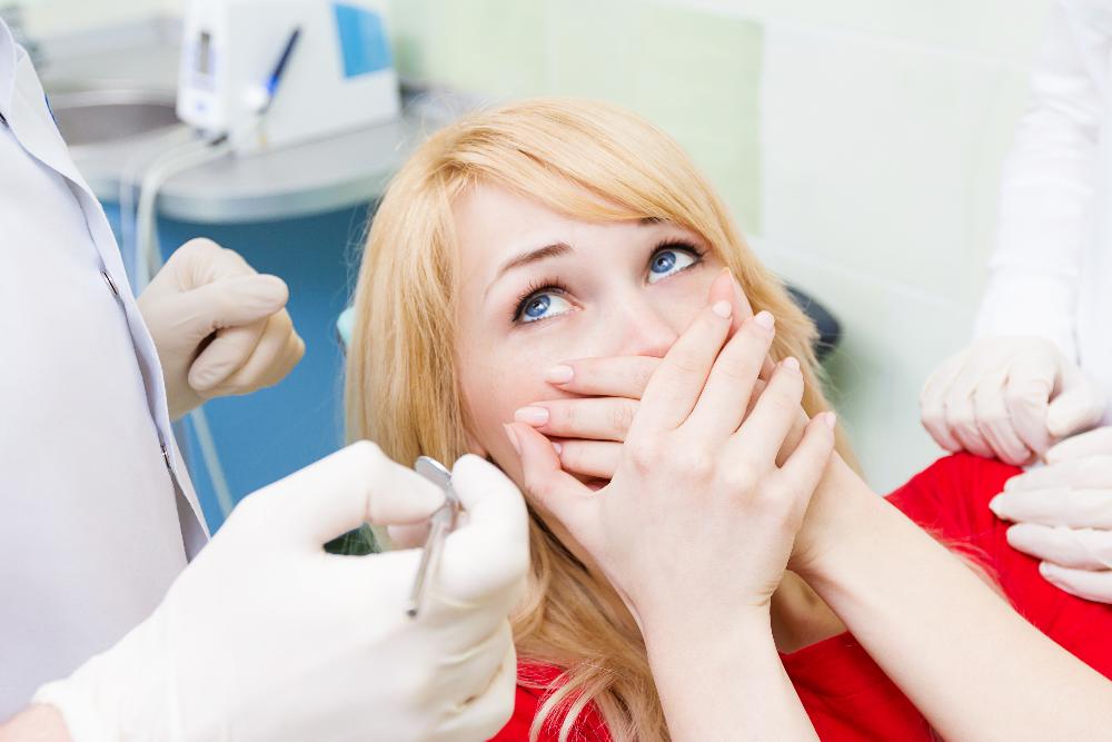 woman holding hands on mouth | dentist parramatta