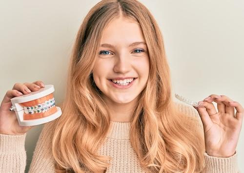 braces parramatta | girl holding aligner and model
