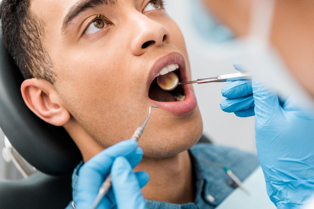man receiving dentist exam | tooth extraction harris park