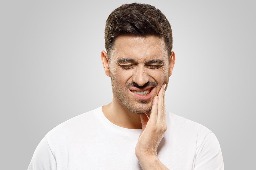 man in pain holding jaw | root canal parramatta