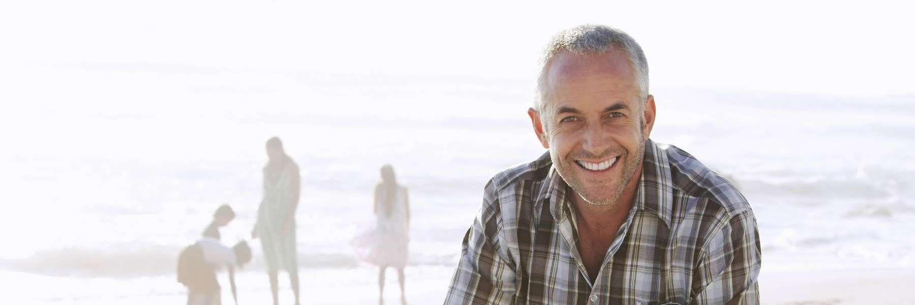 man at beach with all-on-4 implant dentures
