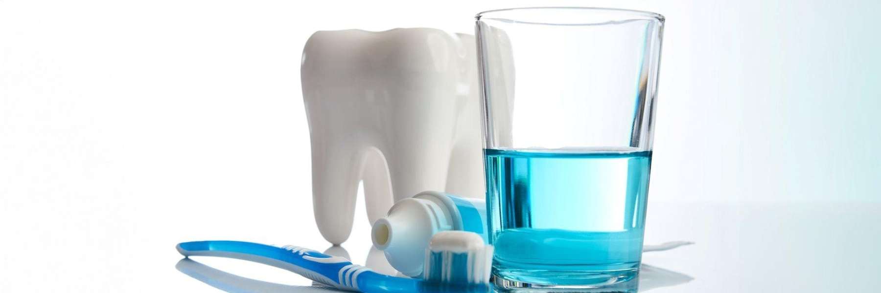 imagery with tooth, toothbrush, toothpaste and mouthwash