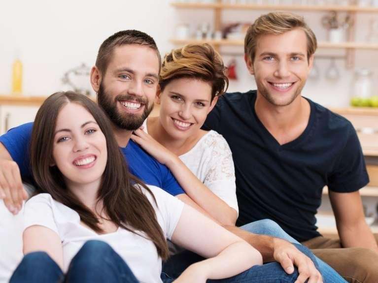 group ogf friends hugging | dental implants harris park