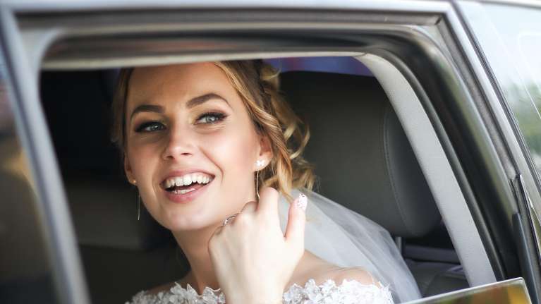 bride riding in vehicle | cosmetic dentist parramatta