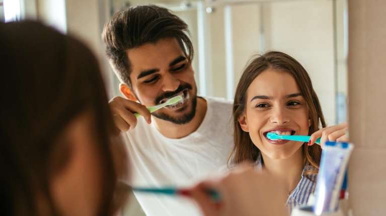 couple brushing their teeth at home in Parramatta