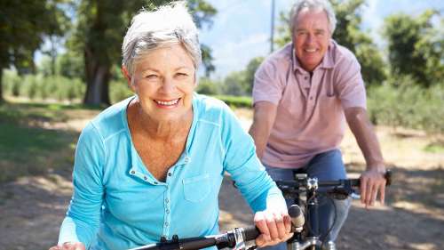 older woman riding a bike | dentist near me
