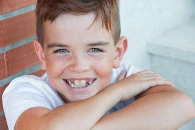 young boy smiling on steps | dental clinic parramatta