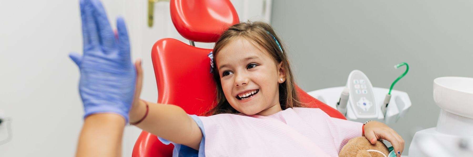 young girl sitting in dentist exam chair | parramatta
